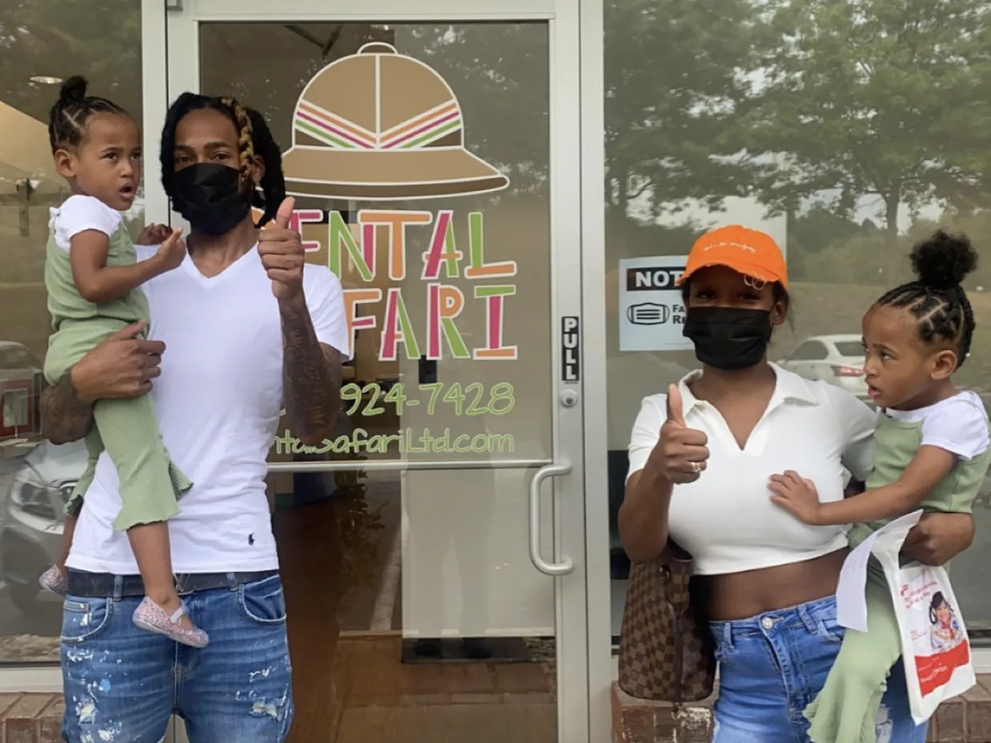A family gives thumbs up outside Dental Safari after their visit