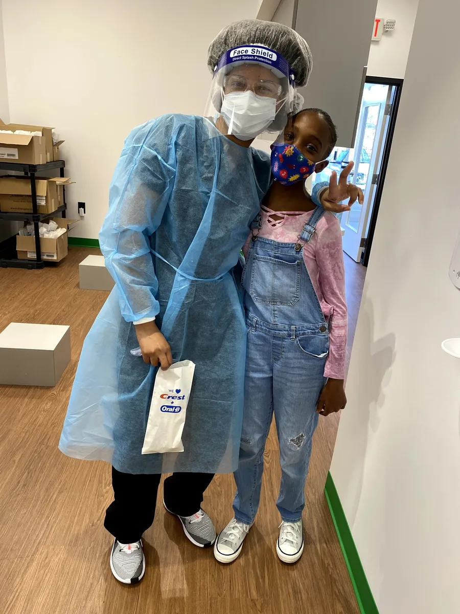 A young patient with a Dental Safari team member